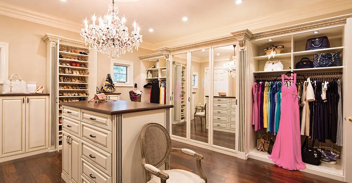 A luxury custom dressing room with an island and integrated lighting.